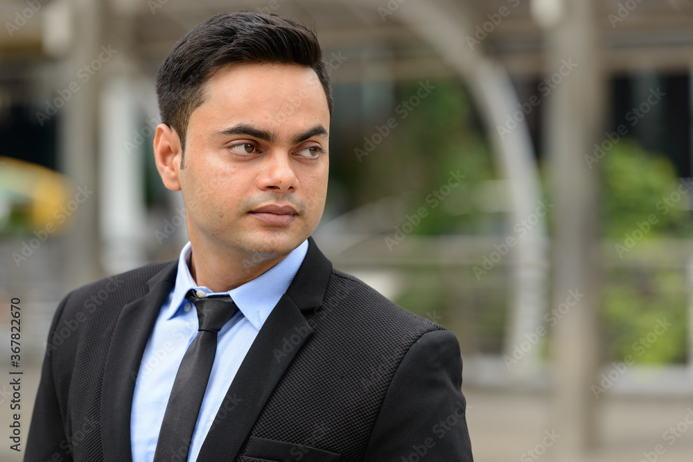Young handsome Indian businessman in the city Young handsome Indian businessman in the city