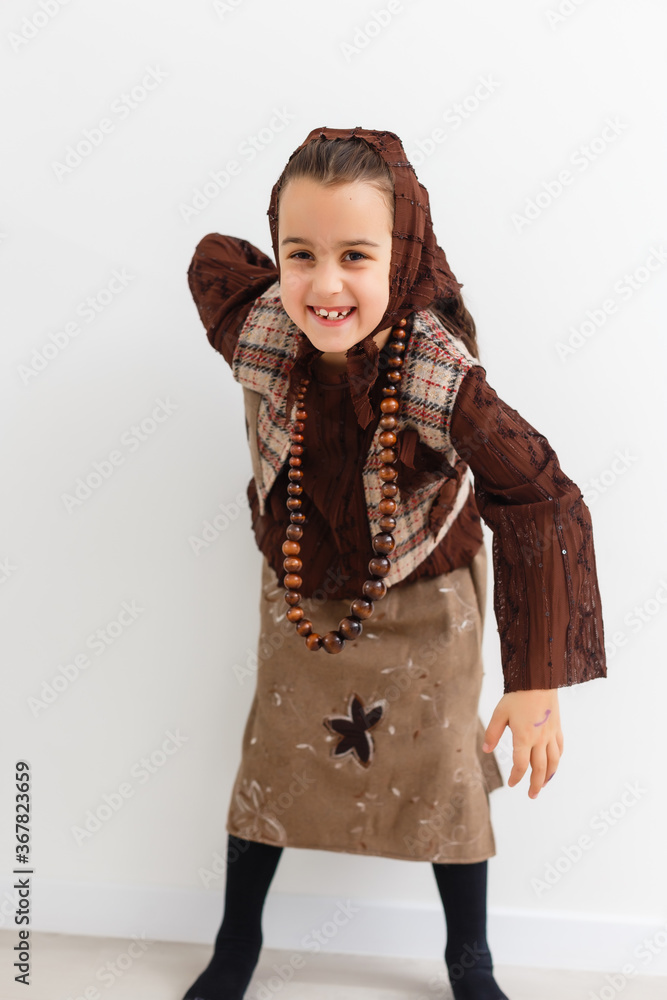 Portrait of little funny girl dressed like an old witch posing with broom in front of White background Portrait of little funny girl dressed like an old witch posing with broom in front of White background