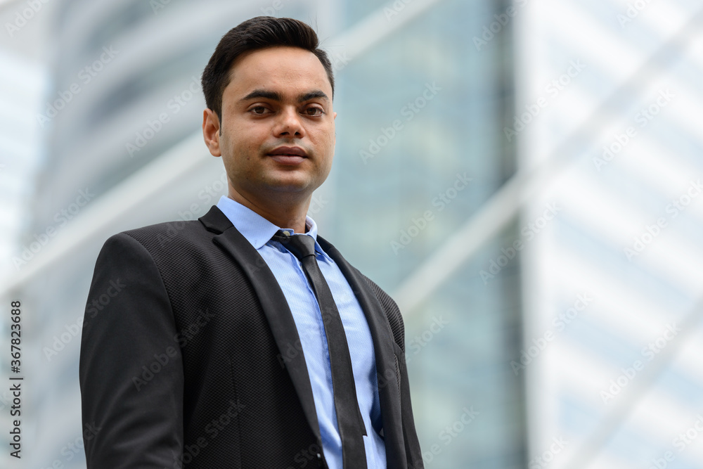 Young handsome Indian businessman in the city Young handsome Indian businessman in the city