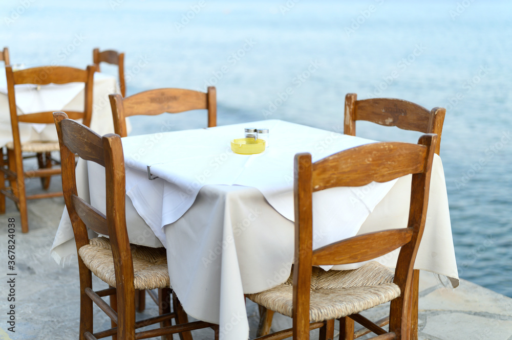 cafe tables on the sea mediterranean embankment. selective focus