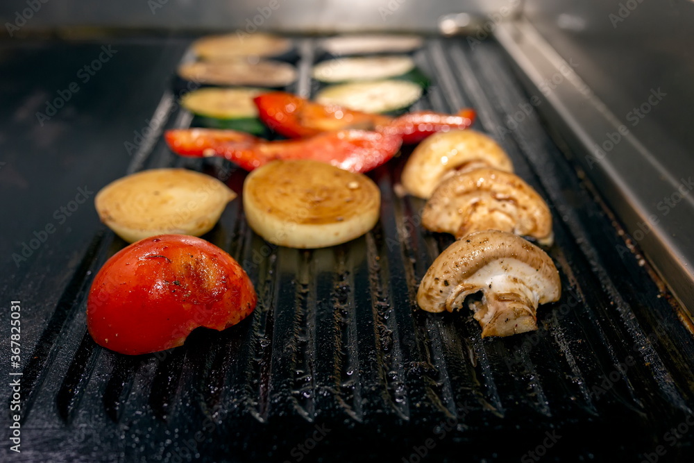 Cooking vegetables grill on the frying surface in black. Cooking vegetables grill on the frying surface in black.