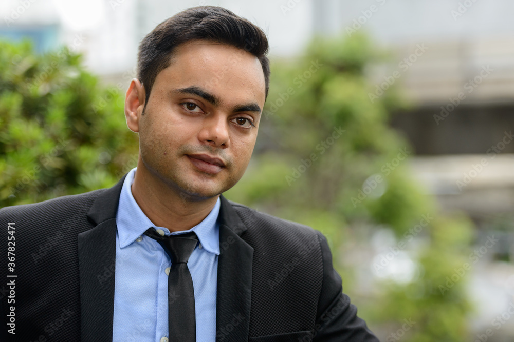 Young handsome Indian businessman in the city Young handsome Indian businessman in the city
