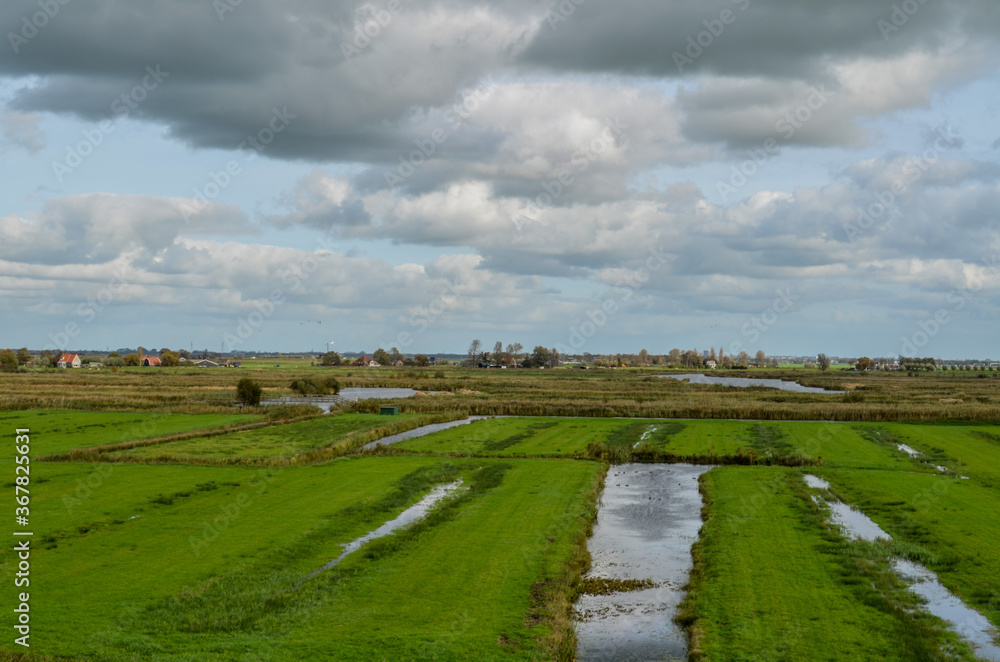 Countryside of netherlands. This is a region with canals, farms and windmills.