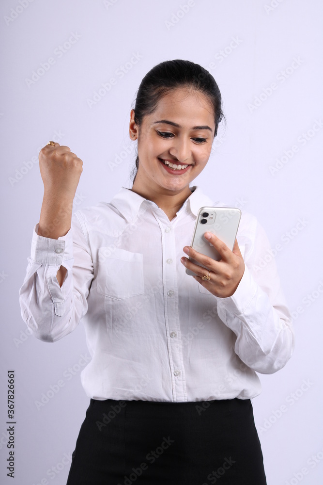 Indian business woman lokking at her phone. Isolated on white background. Indian business woman lokking at her phone. Isolated on white background.