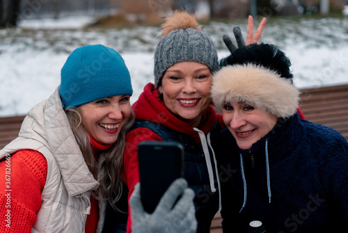 Mature Women Smiling and Making Selfie In Park After Active Outdoor Training. Middle Aged Friends Spending Time Together