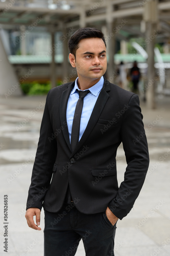 Young handsome Indian businessman in the city Young handsome Indian businessman in the city