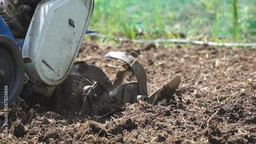 Wallpaper Mural Garden tillers cultivator plowing the land. Close up. Selective focus. Slow motion Torontodigital.ca