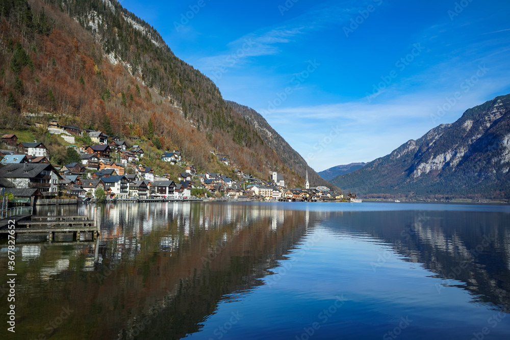 Hallstatt village mountain and lake on a clear blue sky day