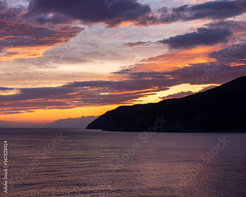 sunset over the italian coast with mountains on the horizon © Alexander