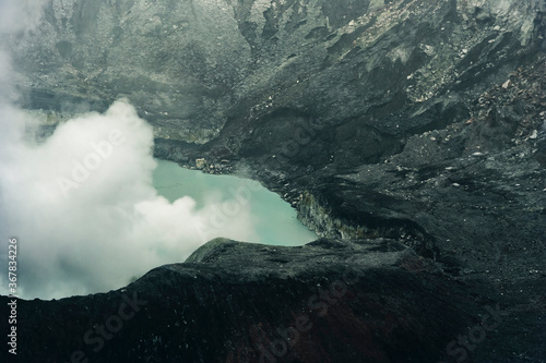 Crater Lake with smoke in Poas Volcano National Park © amelie