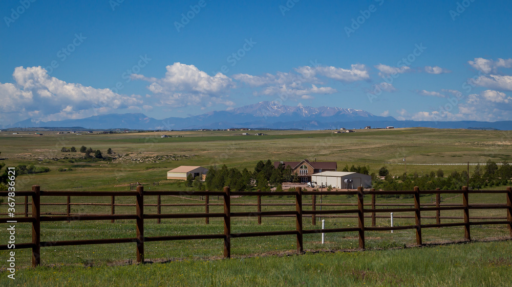 Ranch in Colorado with fence in foreground