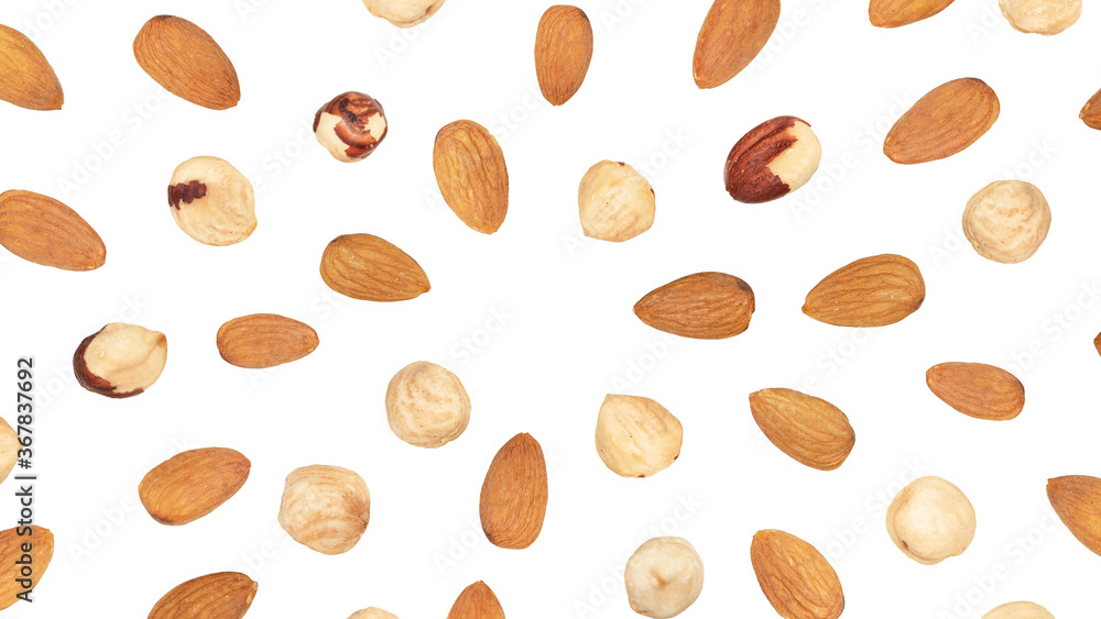 Almond and peeled hazelnuts falling around copy space, isolated on white Almond and peeled hazelnuts falling around copy space, isolated on white