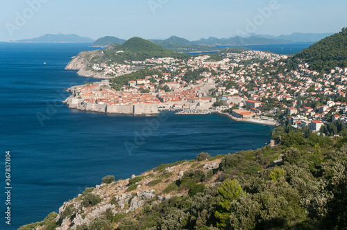 Old pier of Dubrovnik with surrounding mountains and sea.
