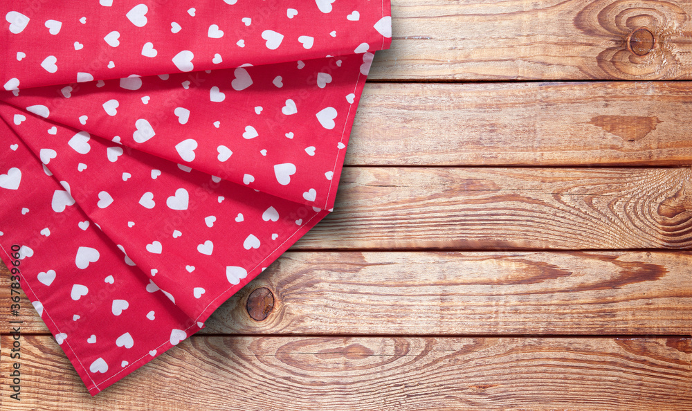 Obraz premium Red table cloth. Stack of colorful dish towels on desk