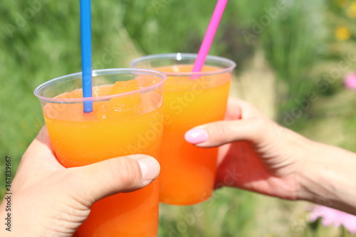 Orange crushed ice in a cup with a straw
