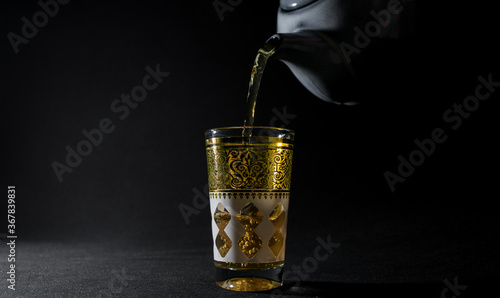 Glass of Arabian tea in the dark