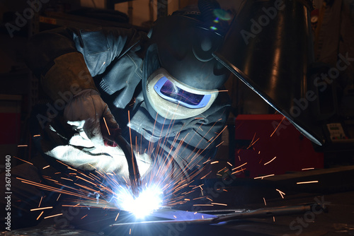 Industrial steel welder in factory technical, The welder is welding metal.