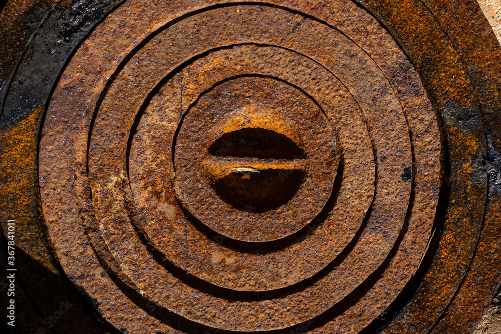 Textured background of rusty rings of iron burner of an old wood stove