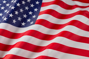 Close up of ruffled American flag. Satin texture curved flag of USA. Memorial Day or 4th of July. Banner, freedom concept