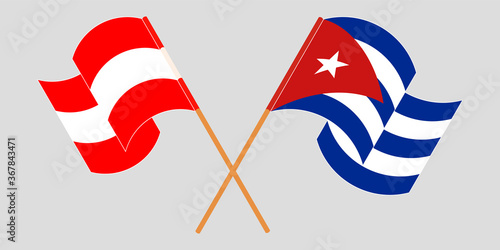 Crossed and waving flags of Cuba and Austria