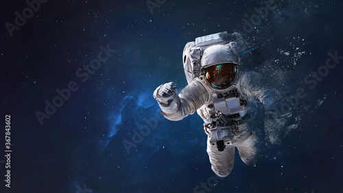 Fototapeta Naklejka Na Ścianę i Meble -  Astronaut from dust in outer space. Space wallpaper. Elements of this image furnished by NASA