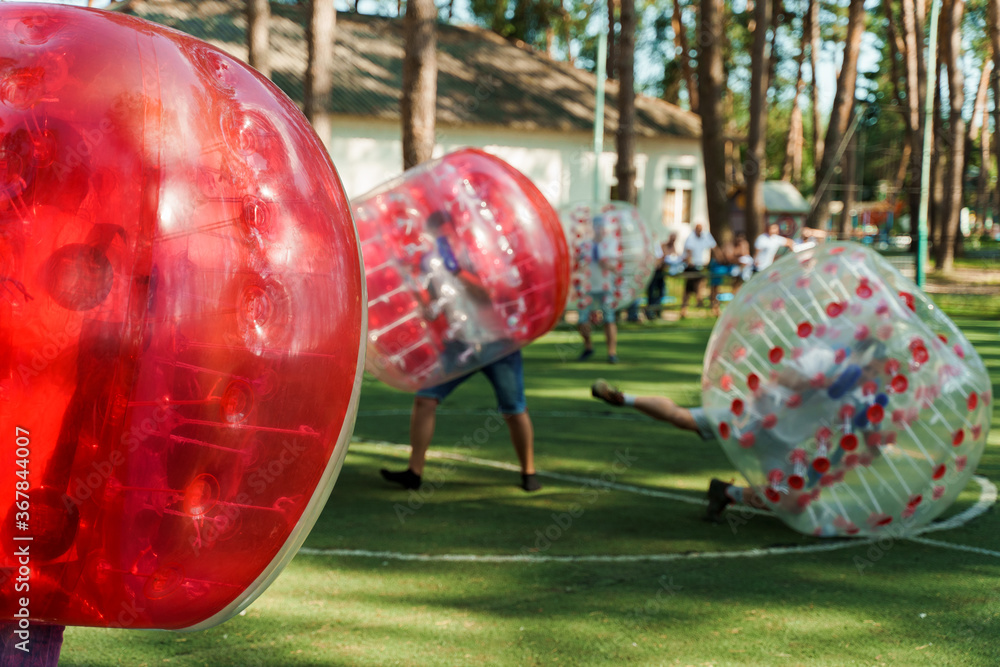 Foto de Bubble football sport game. Football players play bumperball on