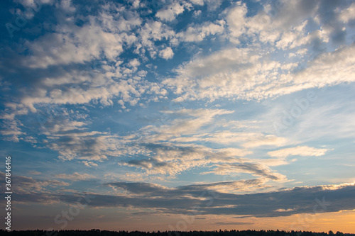 Cumulus sunset clouds with sun setting down © Дмитрий Симаков