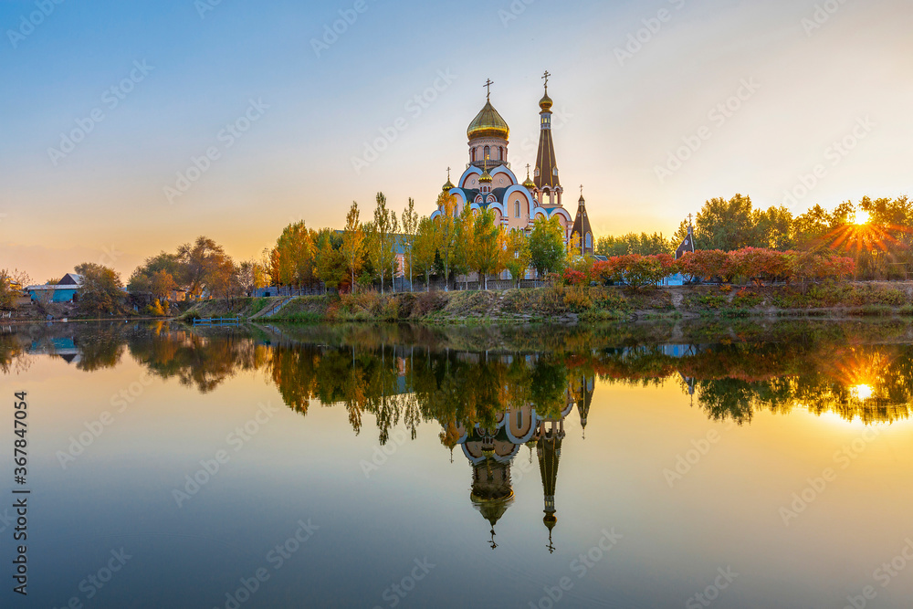 Russian orthodox church in Almaty, Kazakhstan known also as Church of Exaltation of the Holy cross, and its reflection in water. Russian orthodox church in Almaty, Kazakhstan known also as Church of Exaltation of the Holy cross, and its reflection in water.