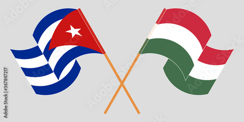 Crossed and waving flags of Cuba and Hungary
