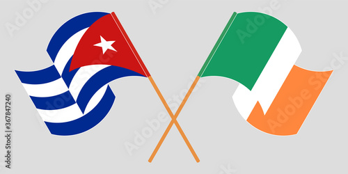 Crossed and waving flags of Cuba and Ireland