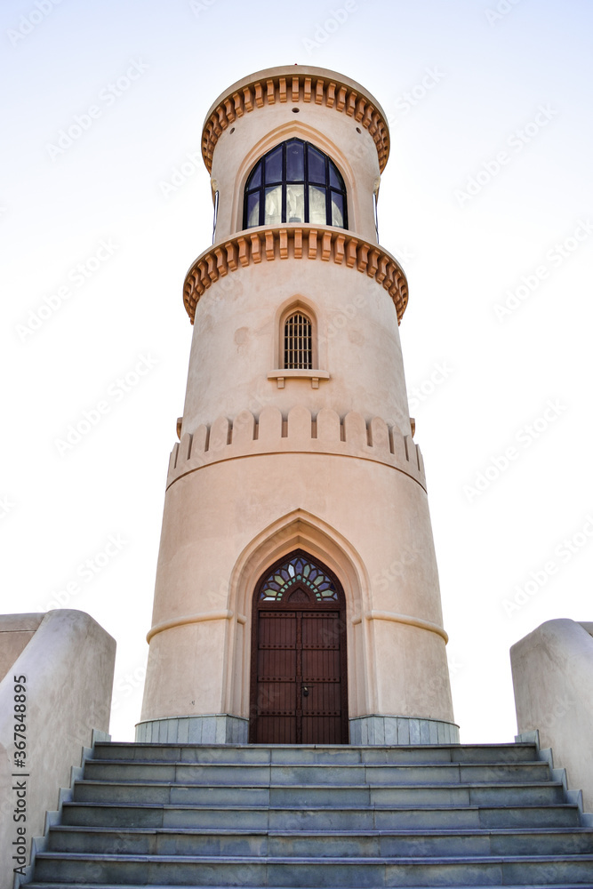 Fototapeta premium Lighthouse at the top of the stairs, in Al Ayjah, Sur, Oman. On the door, there is a sign telling the date it was built: 1996, in the gregorian calendar and 1417, in the arabic calendar.