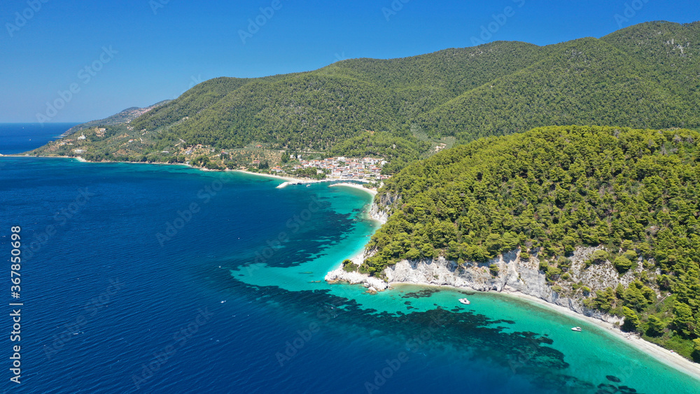 Aerial drone photo of secluded turquoise paradise beaches only accessed by boat of Ftelia and Megalo Pefko covered with pine trees, Skopelos island, Sporades, Greece