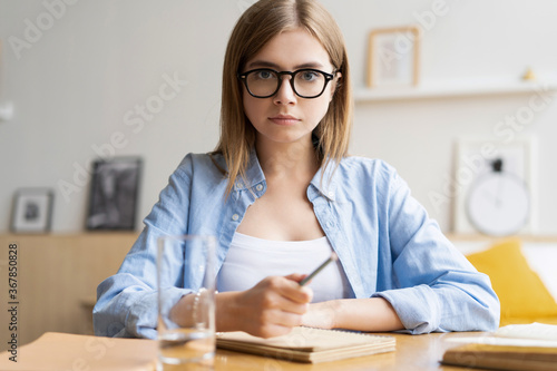 Happy young woman blogger applicant teacher sit at home office look at camera doing online job interview during video chat conference call record vlog teaching on webinar in app, webcam view