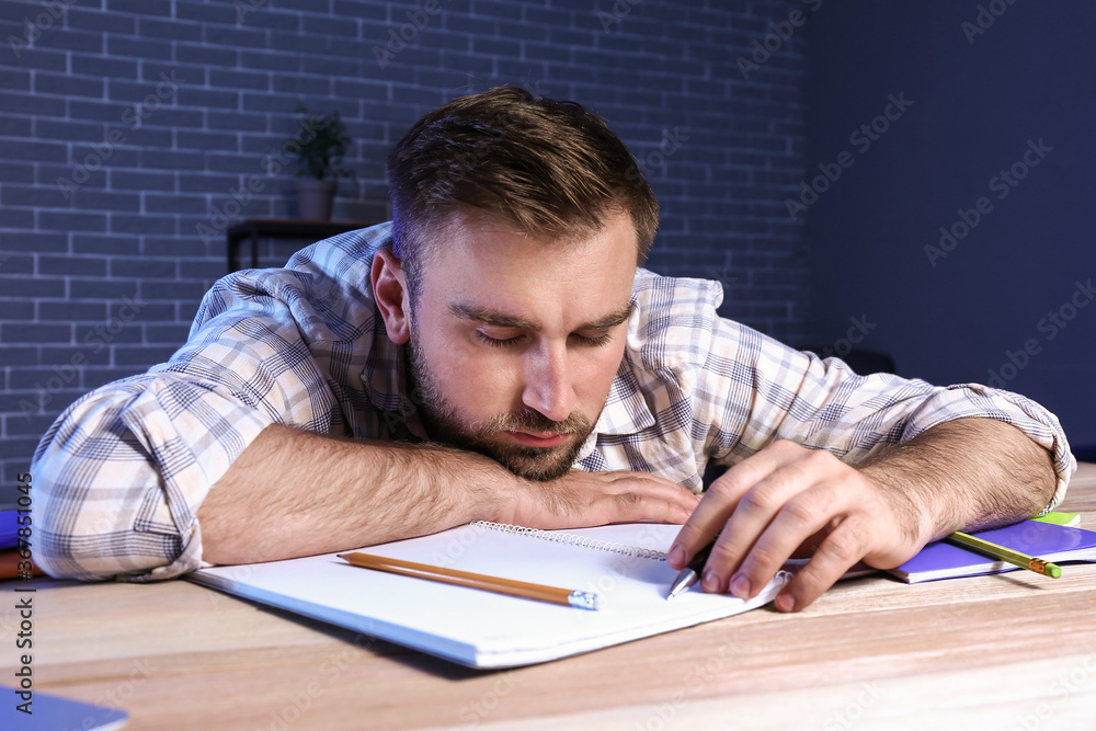 Student sleeping at table late in evening Student sleeping at table late in evening