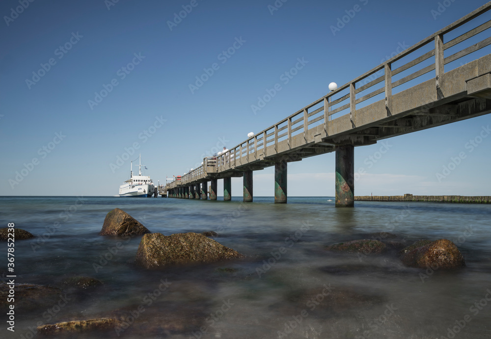 pier with ship on the baltic coast