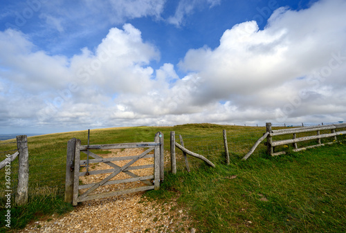 South Downs National Park, Sussex, UK near Firle Beacon. A gate and fence on the route of the South Downs Way. The South Downs Way is a national trail popular with walkers.