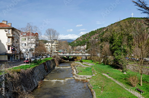 Landscape of the river Bistritsa and the beautiful metal bridge over it with places for recreation and observation, Blagoevgrad, Bulgaria photo