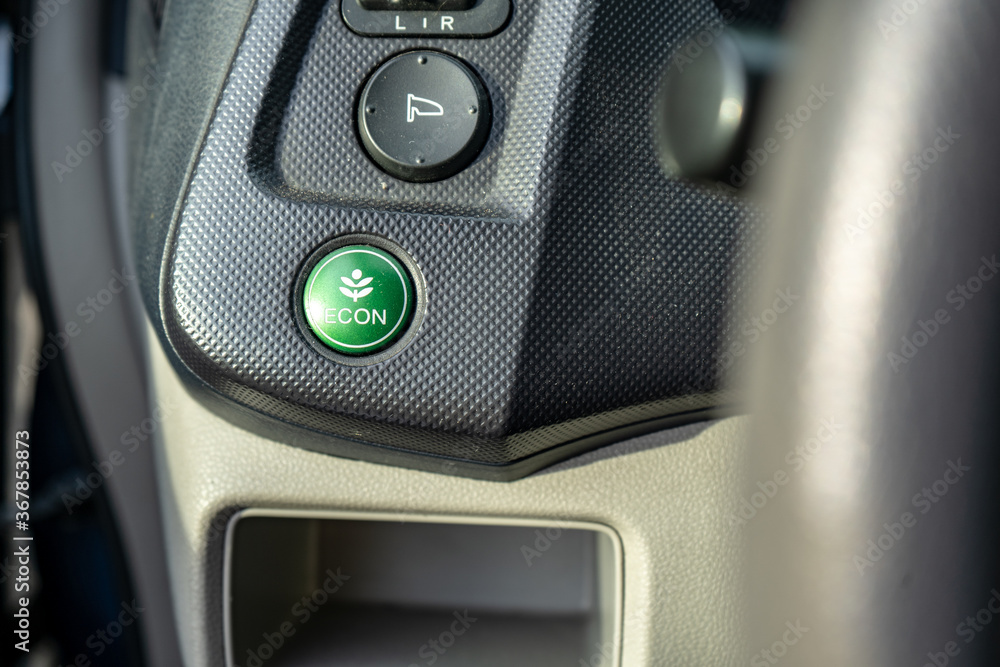 eco button in a hybrid car, switching vehicle to eco mode to save the environment, electric car