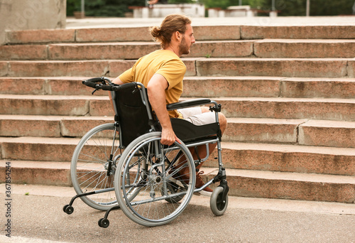 Young man in wheelchair nea...