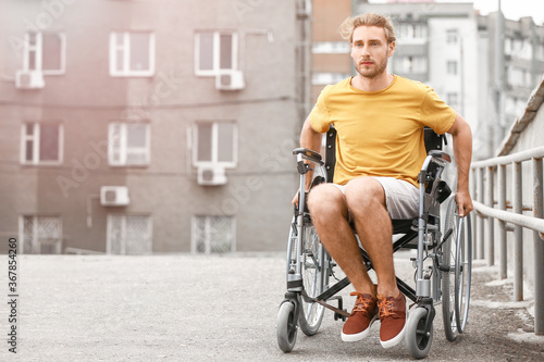 Young man in wheelchair out...