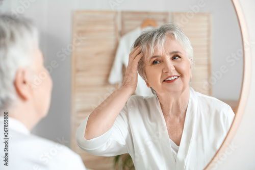 Senior woman looking in mir...