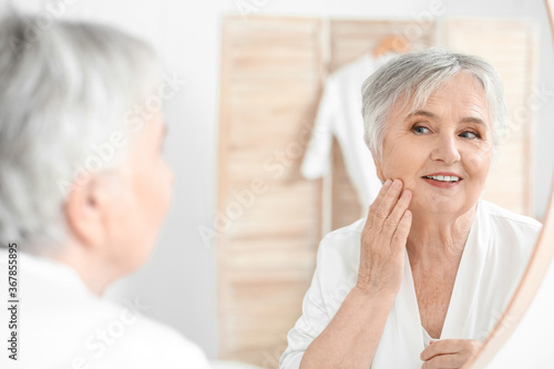 Senior woman looking in mir...