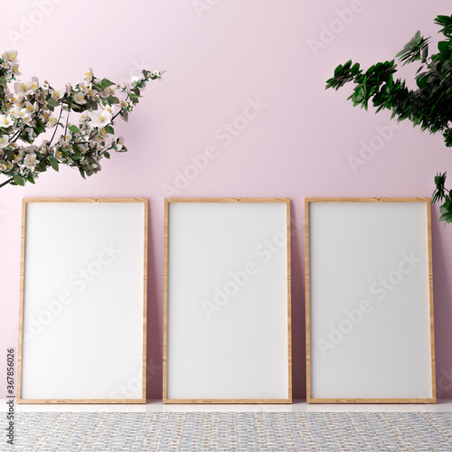 Blank vertical poster frame mock up standing on beige floor. Three wooden frames isolated in Scandinavian interior. 3d render