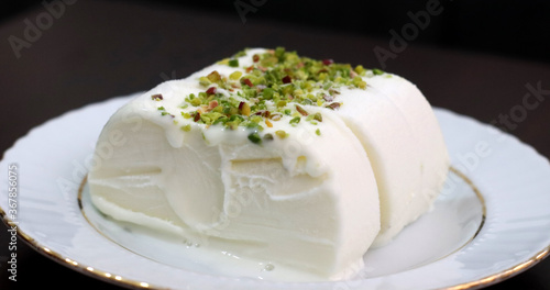 Milk ice cream. Handmade ice cream with pistachio nuts. Maras ice cream. (Maras Dondurmasi) photo