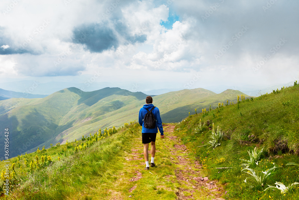 Man hiking in the mountains on a summer day