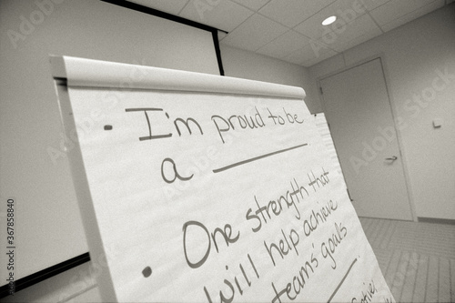 Close-up of motivational text on flip chart in meeting room at office
