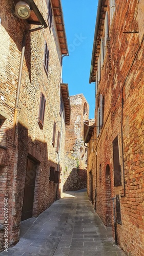 Narrow street with exposure bricks in Città della Pieve, Umbria, Italy. photo