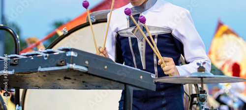 Musician Performing on the field with marching bells. Percussion section performing with other musicians on the field