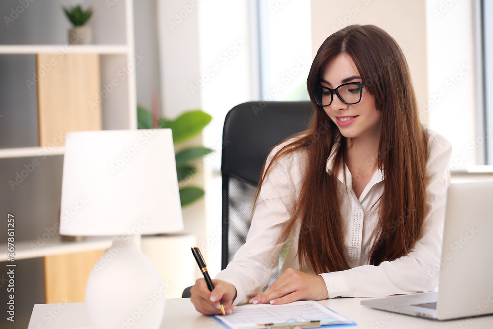 girl working at home with laptop and smiling, brunette in jacket girl working at home with laptop and smiling, brunette in jacket
