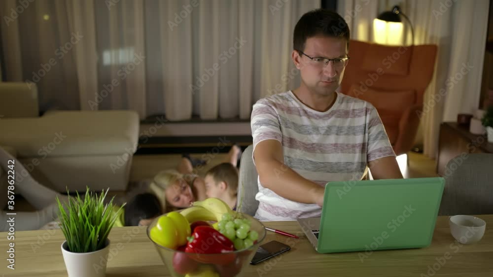 Slomo: Focused Caucasian Father Working At Home While His Family Is Spending Time Together Drawing On The Floor Slomo: Focused Caucasian Father Working At Home While His Family Is Spending Time Together Drawing On The Floor